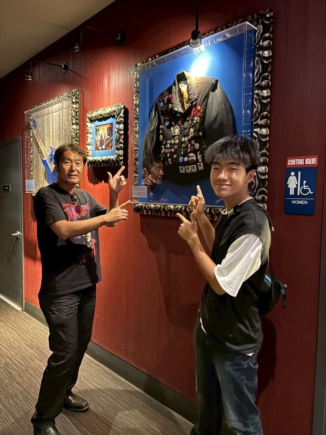 Guide Imai showing guests a Michael Jackson-related exhibit.